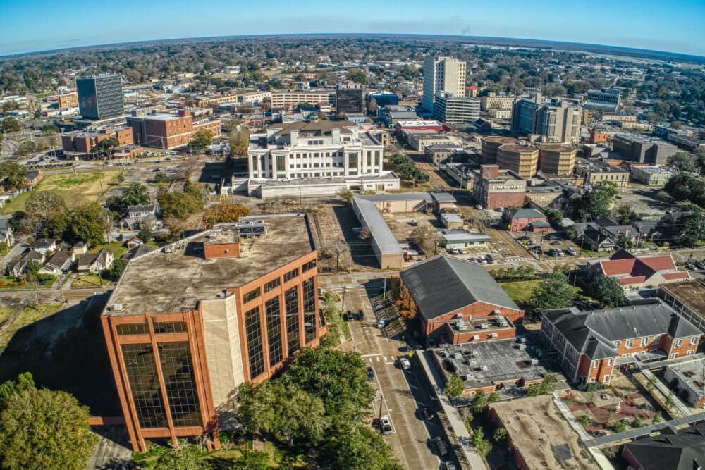 Aerial view of a city skyline featuring a mix of modern and older buildings.